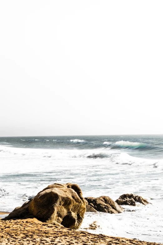 a lone surfer is coming to the waves