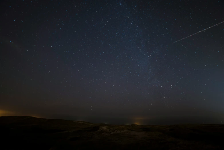 a sky with an airplane flying in the distance