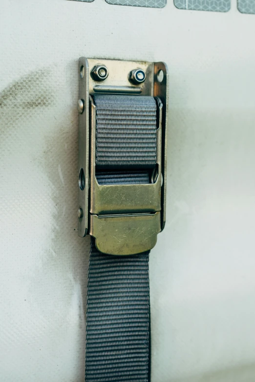 a close up of a metal clasp on a strap