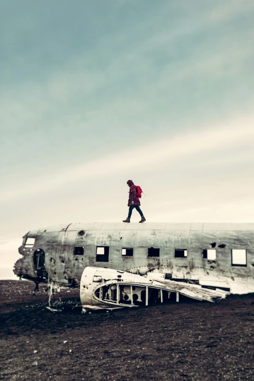 a man walks on the roof of an old airplane