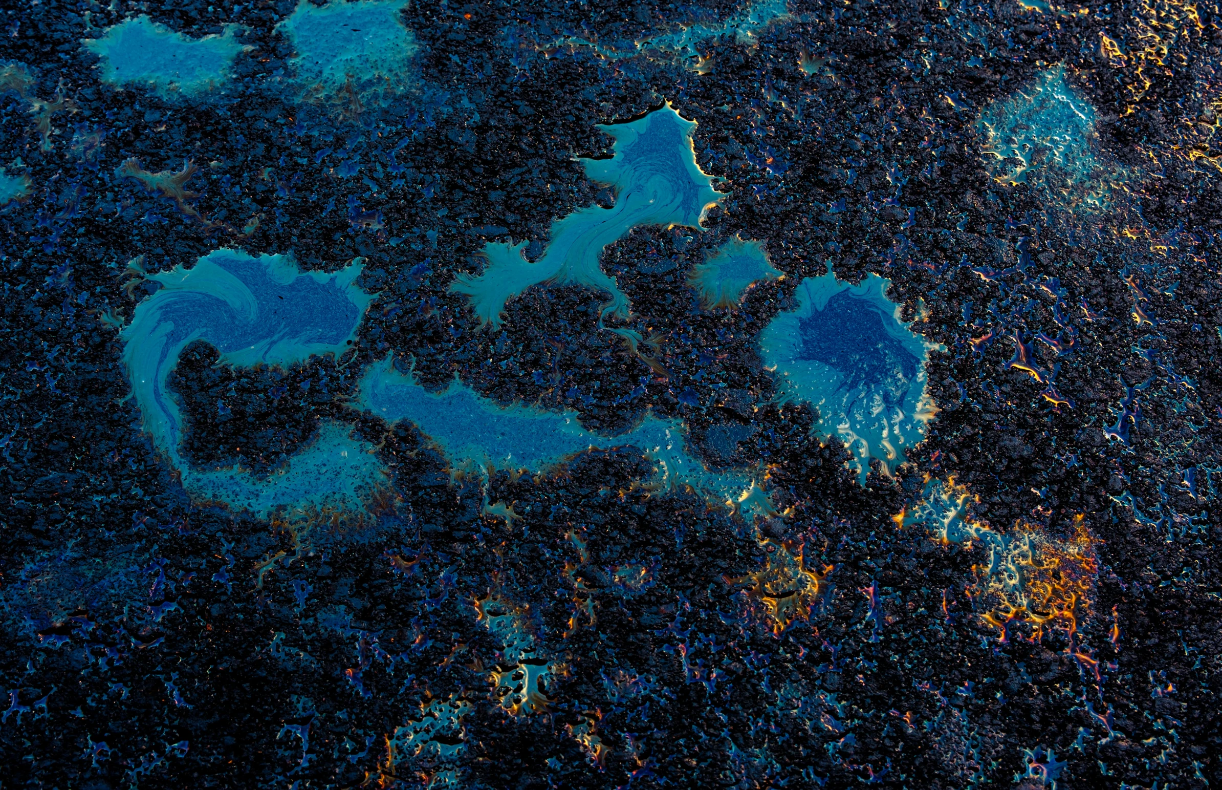 an aerial view of water and land at night