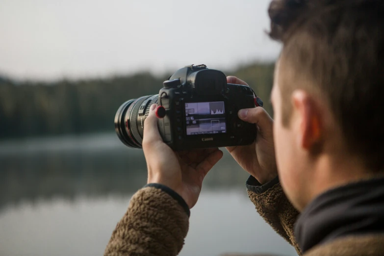 a man is looking at his video camera