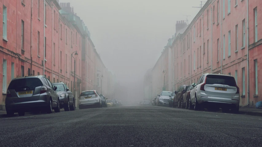 some cars parked on a narrow city street