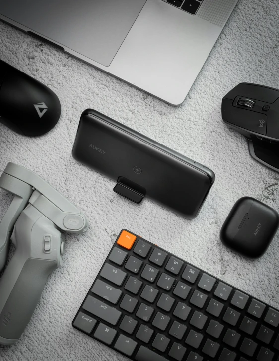 a desk with many different mouses, keyboard and tablet