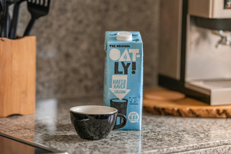 a package of oat ly next to a coffee cup