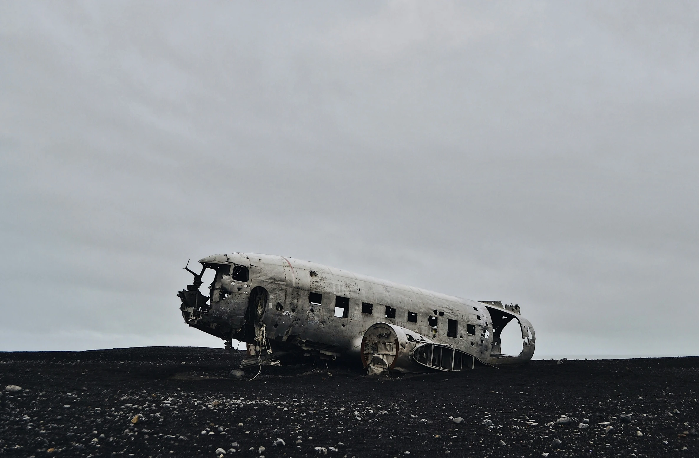 an old plane that has been abandoned on top of a hill