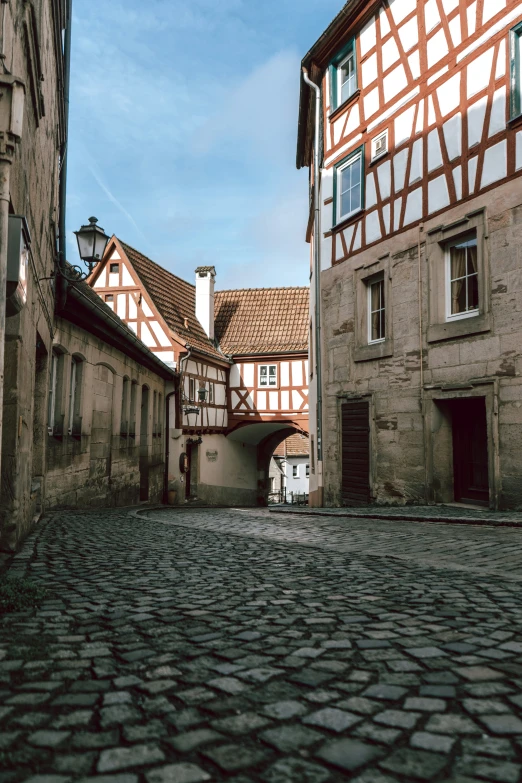 an alley way with a street lined with stone buildings