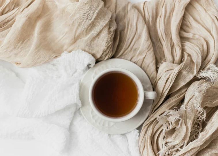 an overhead s of a coffee cup with soing else in the background