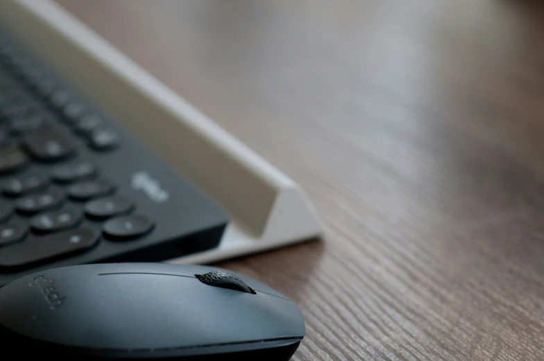 the computer mouse is next to the keyboard on the table