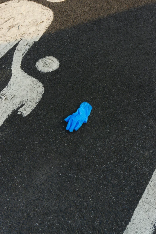 a blue piece of plastic on the ground