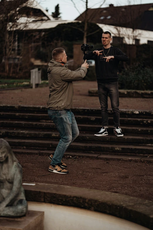 two people are standing on the steps of a house