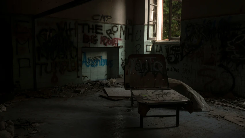an abandoned hospital room filled with graffiti