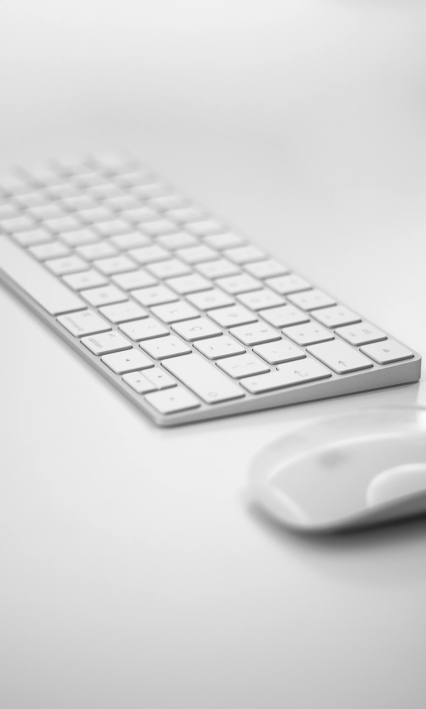 a keyboard sitting next to a mouse on a table