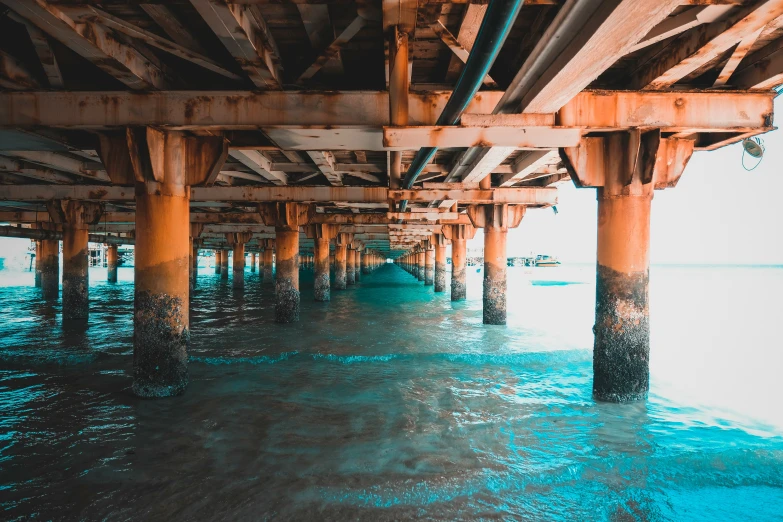 the underside of an overpass with water beneath