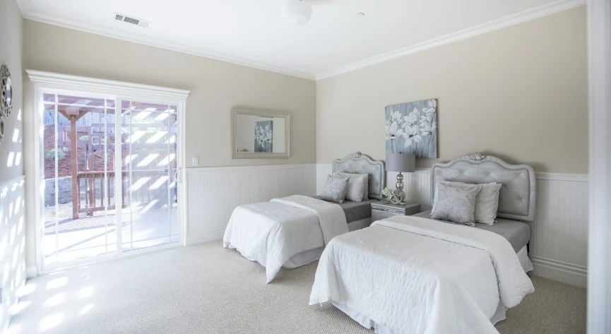 a bedroom with two twin beds and a sliding glass door