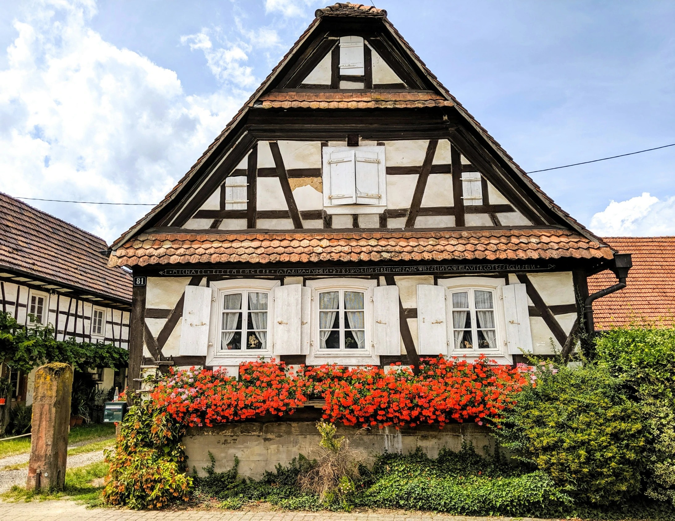 there is a small house with white shutters