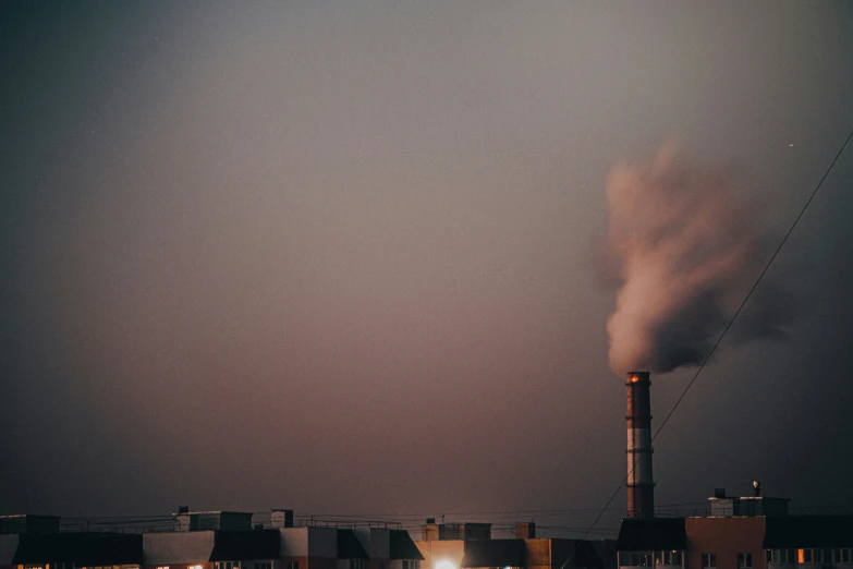 smoke pouring out of a tower in the sky