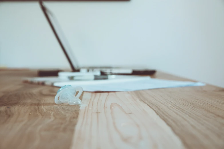 a computer keyboard on top of a wooden desk