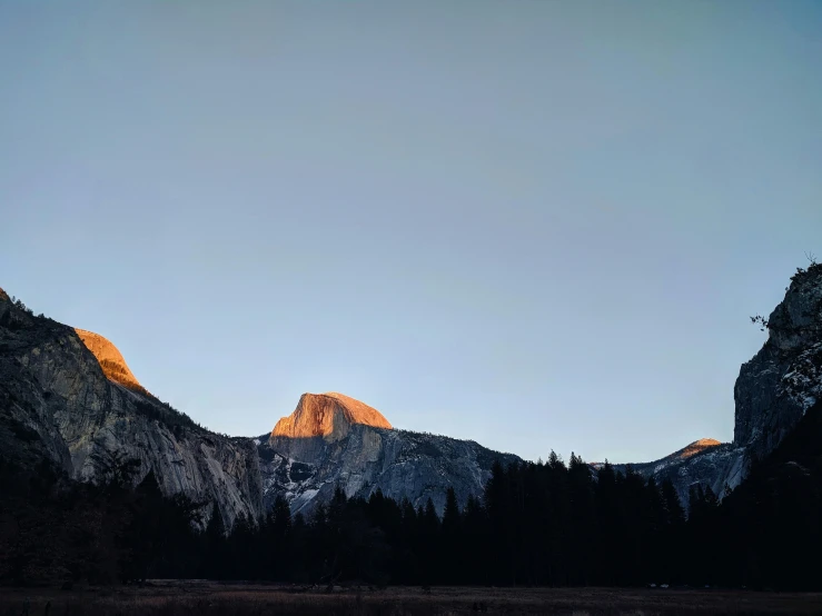 mountains with a sky view and some trees in the foreground