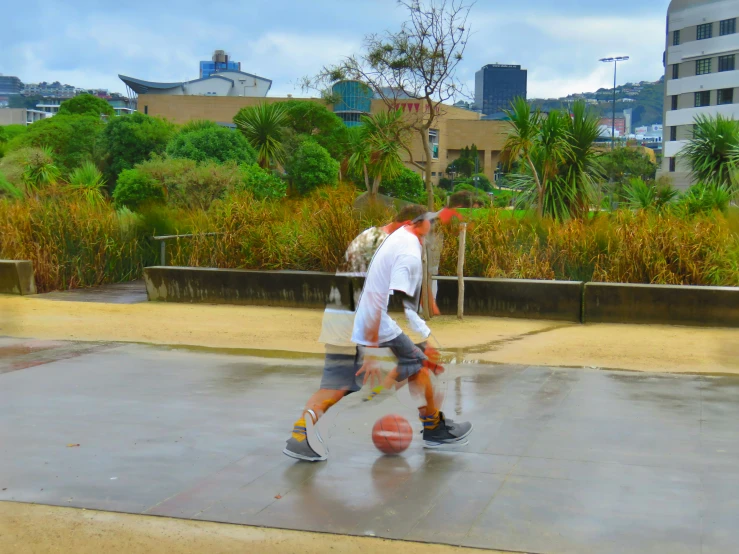 a young man playing with a basketball ball in a plaza