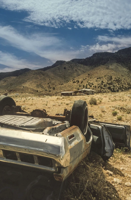 a car is sitting in the dirt outside