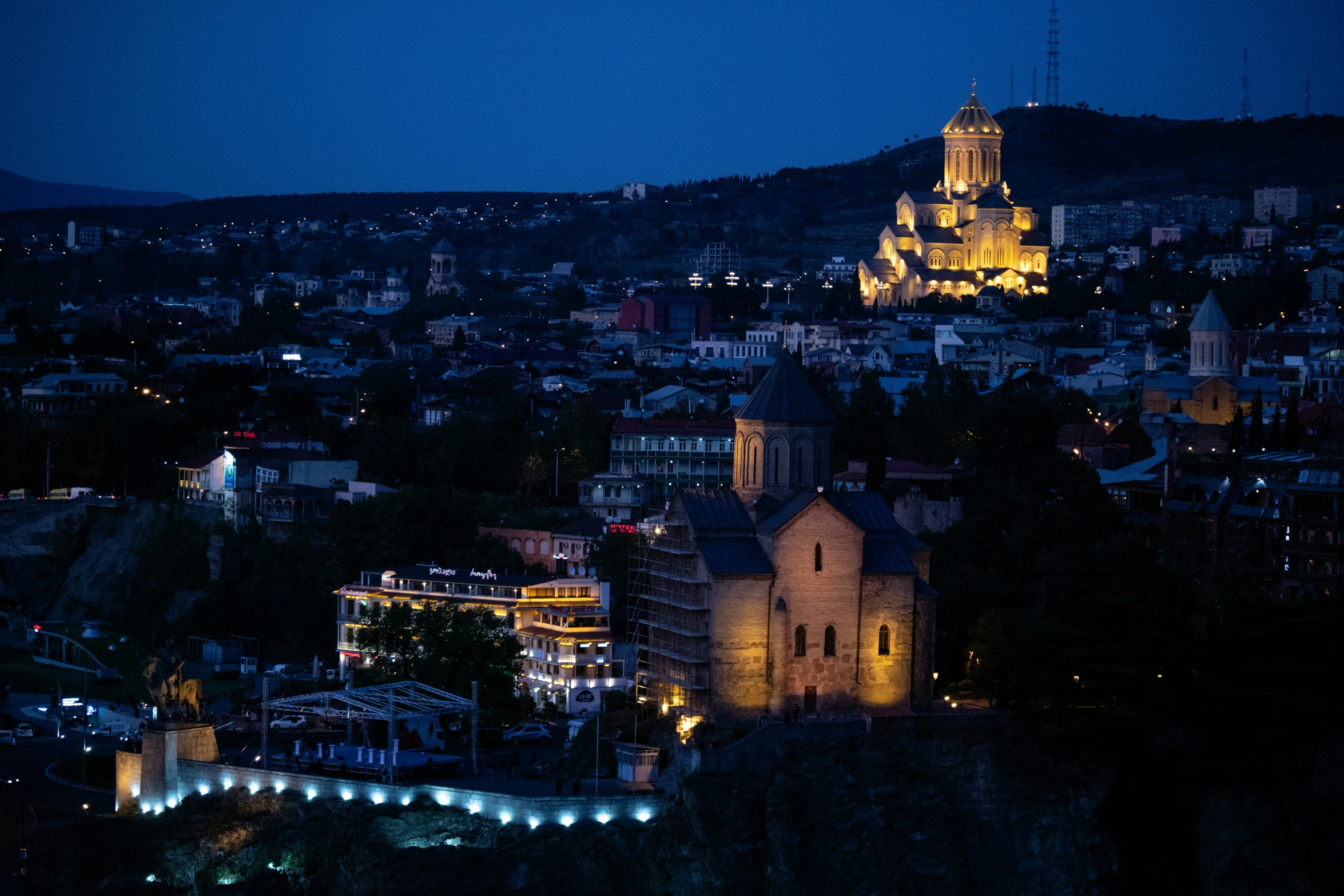 a nighttime s of a town in a city with the lights on