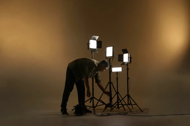 a man lighting up a set of lights with his hands