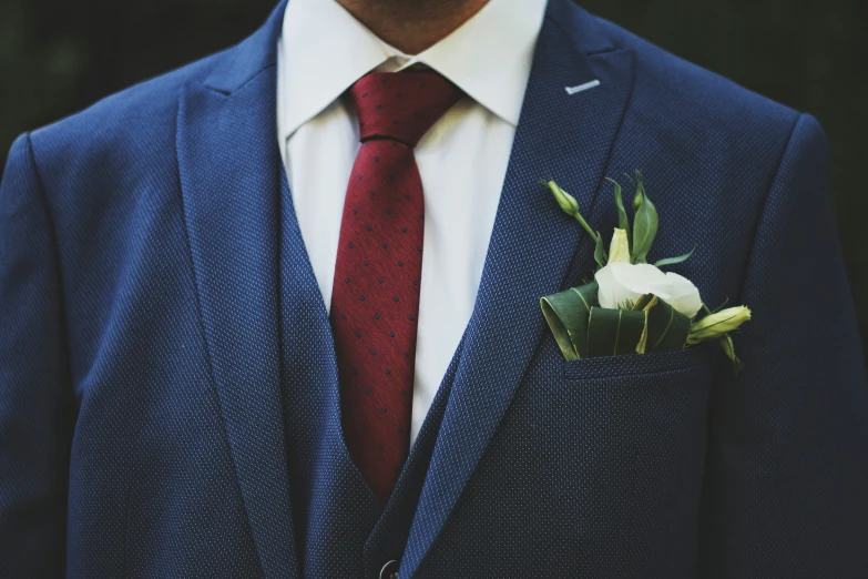 a person with a red tie and a blue suit