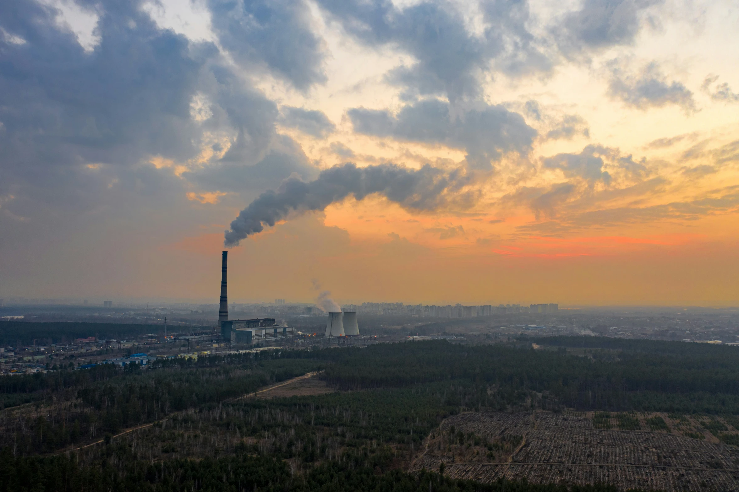 a large pipe emitting a lot of air pollution into the sky