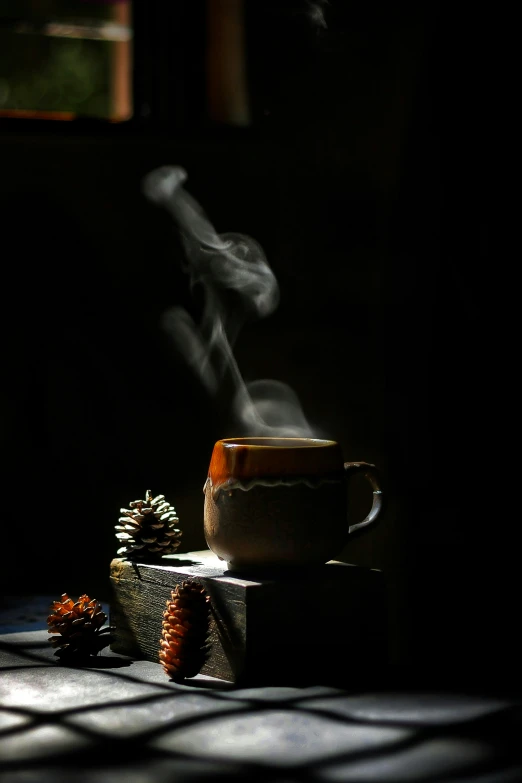 the smoke is coming out of a tea cup