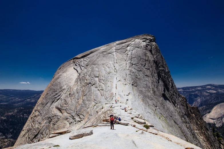 the hikers are standing at the top of a mountain