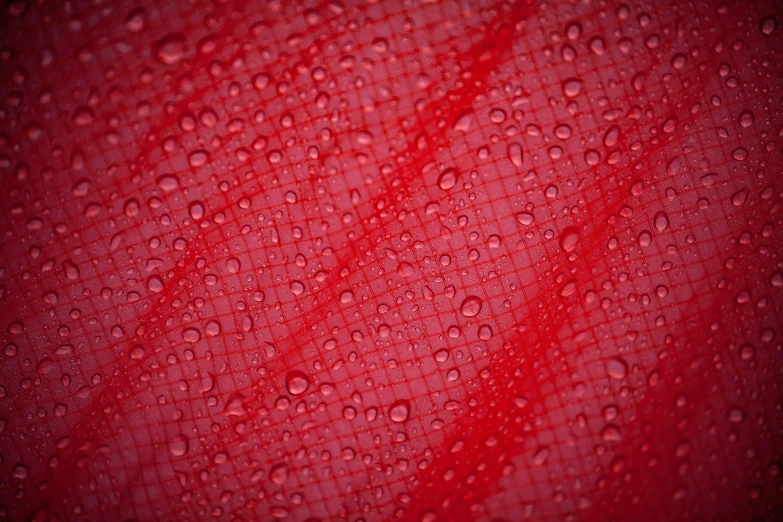 an abstract background with water drops and a red texture