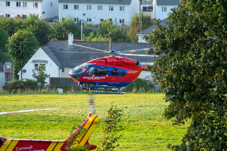 a helicopter is flying over a park and grassy area