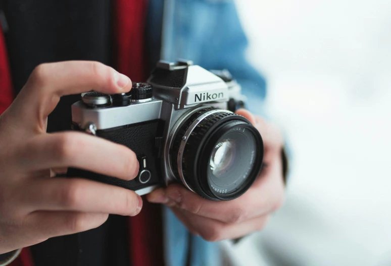 person holding camera in their hands next to each other