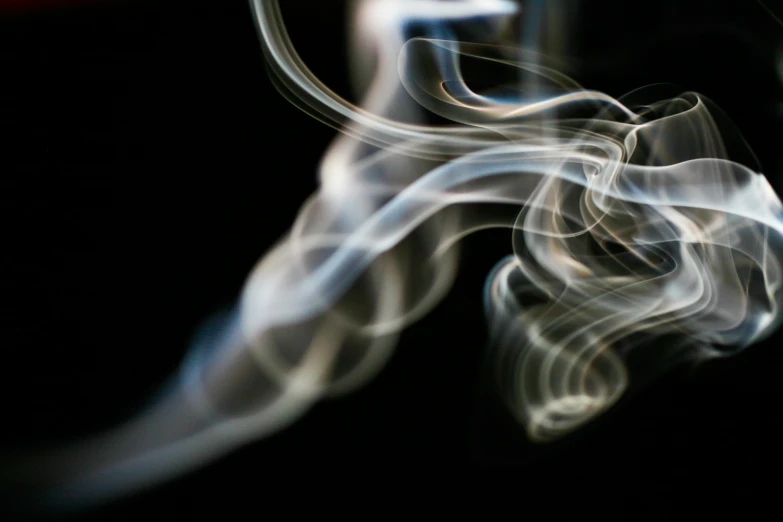 a black background with smoke coming out of it