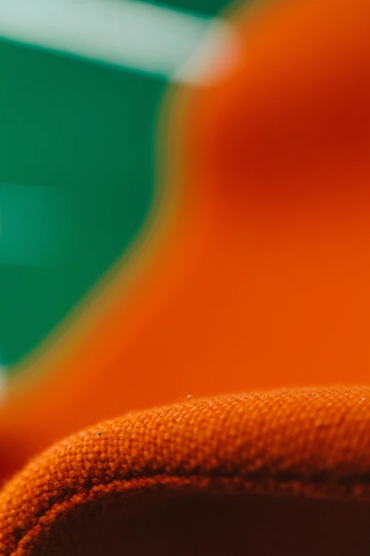 close up of a orange chair with an orange seat