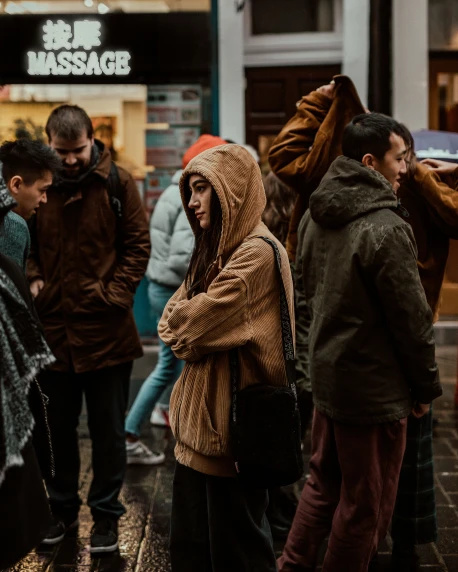 people standing on a street in the rain