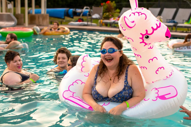 a lady that is floating in the water with an air mattress