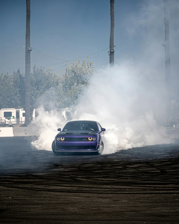 blue car on the road during smoke bomb