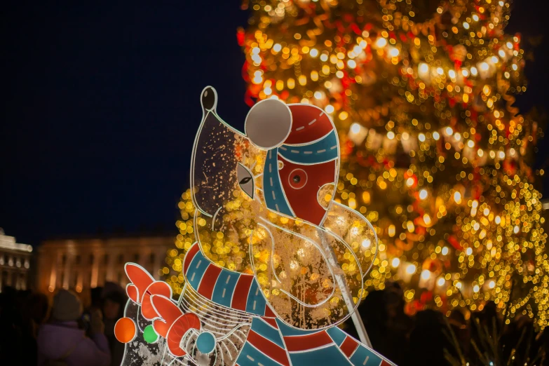 a large colorful christmas decoration is lite up