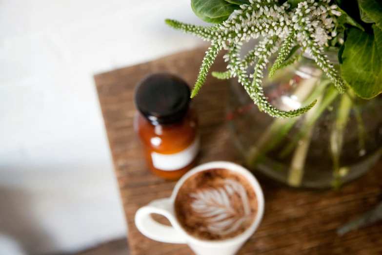 a flower and a cup of coffee sitting on a table