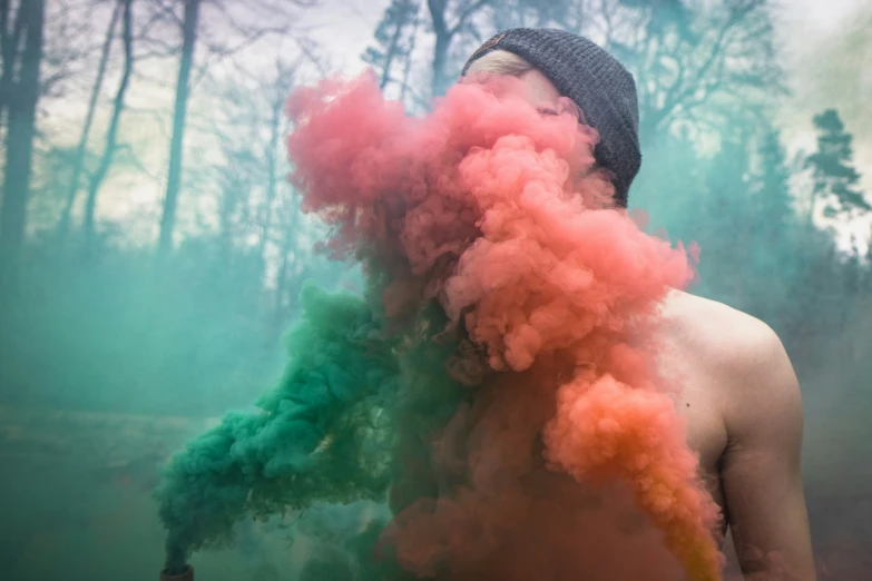 the young man is holding a multi colored stick