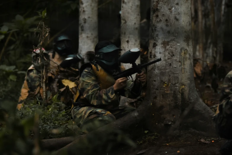 soldiers with face masks are in a wooded area