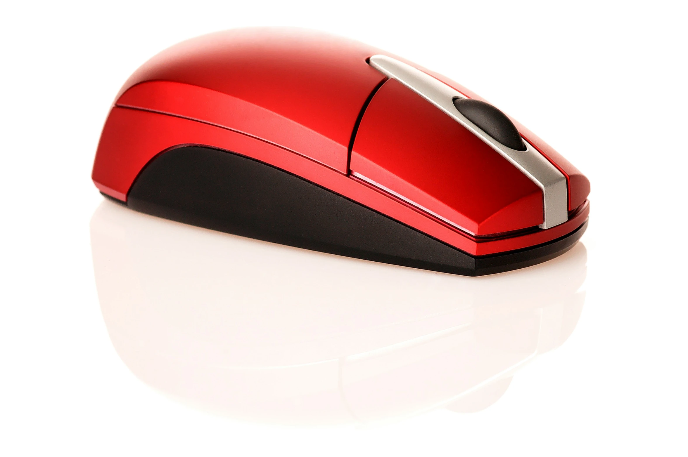 a red computer mouse is laying flat on the ground