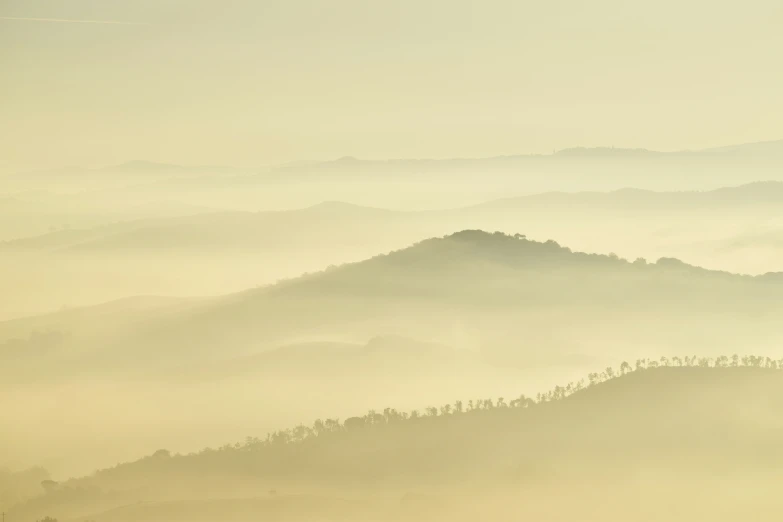 the view of a foggy mountains covered in trees