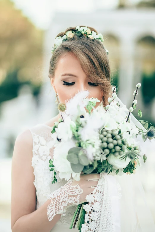 a bride looks down at her bouquet
