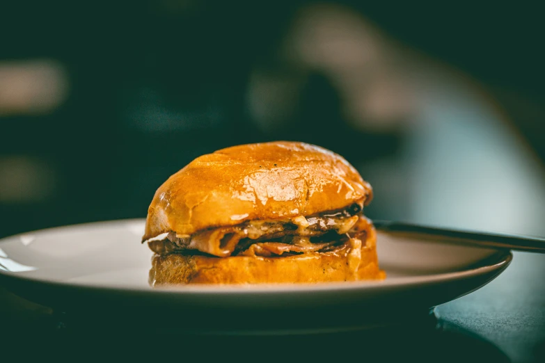 a cheeseburger with pork is shown on a plate