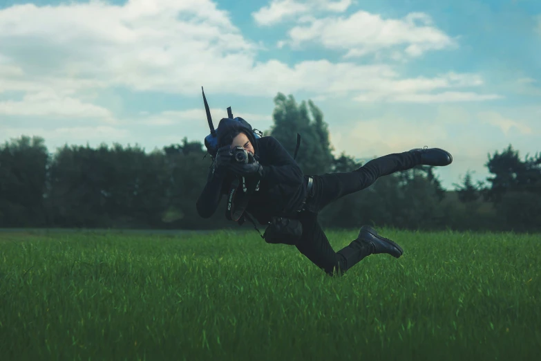 a person in the air holding guns above their head