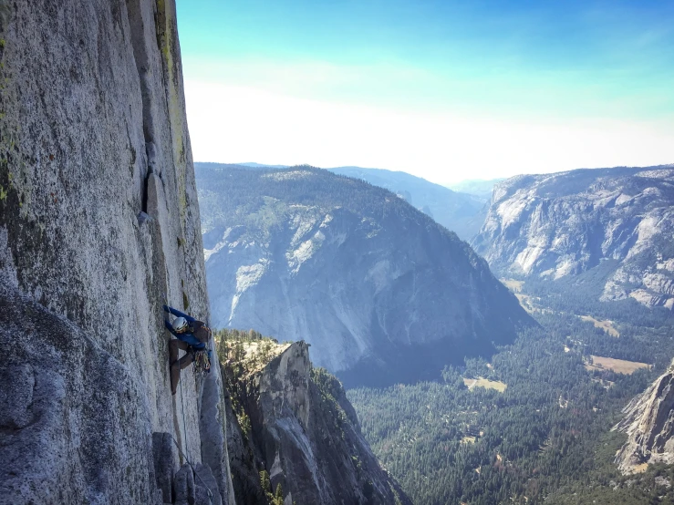 a person is climbing on top of a mountain