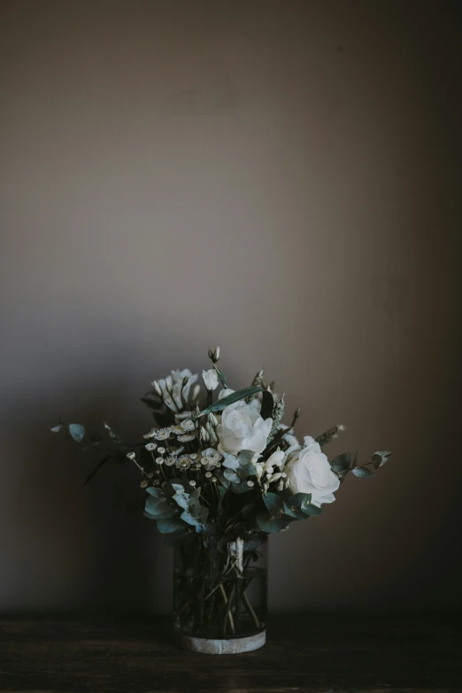 flowers in a clear vase stand on a table